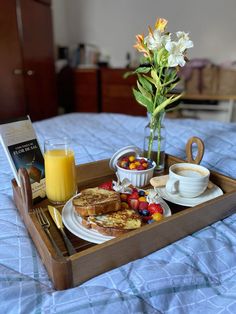 a breakfast tray with fruit, toast and juice