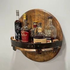 a wooden barrel shelf with liquor bottles on it