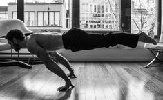 a man is doing push ups in the living room