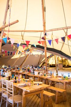 a large tent with tables and chairs set up