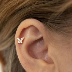 a close up of a person's ear with a small flower on the side