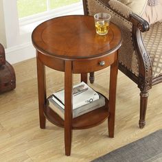 a small wooden table with a glass on it