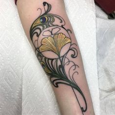 a person with a tattoo on their arm that has an image of a flower in it