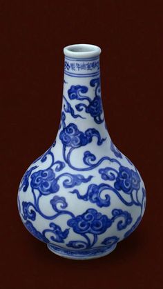 a blue and white vase sitting on top of a table