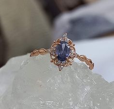 a close up view of a ring on top of a piece of rock with crystals