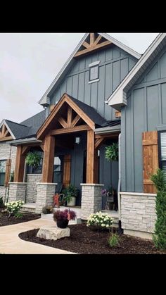 a gray house with wood trim and windows