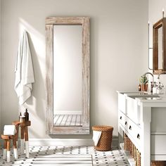 a bathroom with a sink, mirror and towel rack