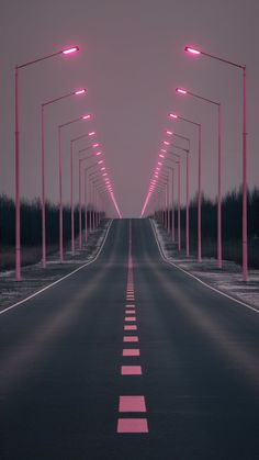 an empty road with pink lights on both sides