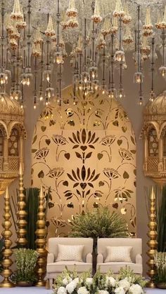 an elaborately decorated room with chandeliers and flowers on the table in front of it