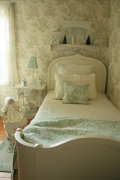 a white bed sitting in a bedroom next to a window