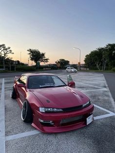 a red sports car parked in a parking lot