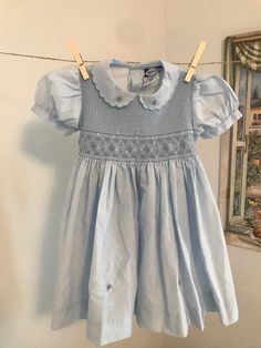 Beautiful vintage blue toddler girl smocked dress  Brand: Carriage Boutiques  Size : 24 months  Cotton and polyester Fitted Light Blue Smocked Dress With Smocked Cuffs, Vintage Summer Dress With Smocked Cuffs, Light Blue Fitted Smocked Dress With Smocked Cuffs, Spring Vintage Smocked Dress, Fitted Light Blue Smocked Dress For Daywear, Cute Blue Smocked Dress With Ruffles, Blue Smocked Dress With Puff Sleeves And Ruffles, Cute Blue Dresses With Smocked Cuffs, Blue Puff Sleeve Smock Dress