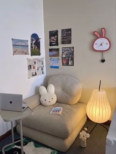 a living room with a couch, chair and laptop