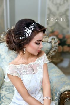 a woman sitting on top of a couch wearing a tiara