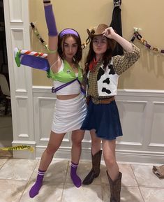 two girls dressed in costumes posing for the camera