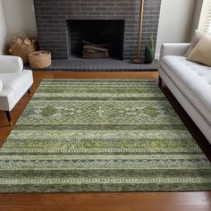 a living room with a fire place, couches and a rug on the floor