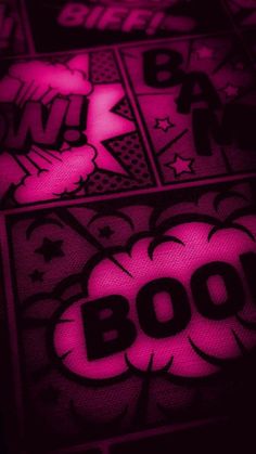 the word boo is lit up in pink and black with white stars on it's side