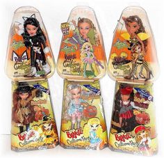 four different dolls in plastic packaging on a white background