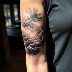 a person with a cloud tattoo on their arm