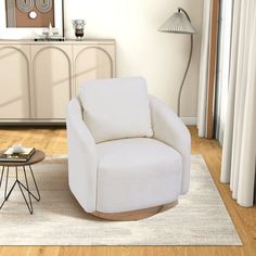 a living room with a white chair and side table