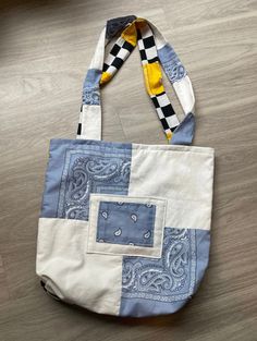 a blue and white bag sitting on top of a wooden floor