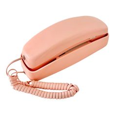 an old pink phone is laying on its side with the cord still attached to it