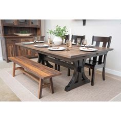 a dining room table with two benches in front of it