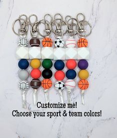 an assortment of sports balls and key chains with the words customize me choose your sport & team colors