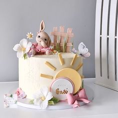 a cake decorated with an easter bunny and flowers