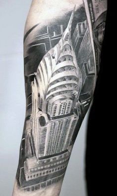 a man's arm with a black and grey cityscape tattoo on it