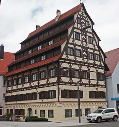 an old building with many windows on the side of it and cars parked in front