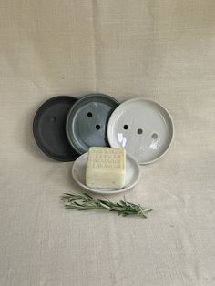 three plates with soap and rosemary on them