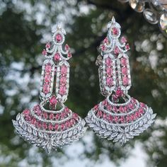 Silver Ruby diamond earrings are  Indian bollywood Desiner Style pair. Oversized Chandler earrings cute look high end pieces. Perfect for any stage or Evening party such like Wedding,  Stage shows,  Fashion modeling. Indian jewelry/Indian wear /pakistani jewelry/ Cz jewlery/ American Diamond Earrings/ Celebrity Earrings/Desi jewelry Glamorous Festive Wedding Earrings, Glamorous Wedding Earrings For Festive Season, Glamorous Wedding Earrings For Festive Occasions, Party Chandbali Earrings With Cubic Zirconia, Traditional Silver Chandelier Earrings With American Diamond, Dazzling Party Chandelier Earrings Hand Set, Dazzling Hand-set Chandelier Earrings For Party, Elegant Pink Earrings For Reception, Silver Chandbali Diamond Earrings For Wedding