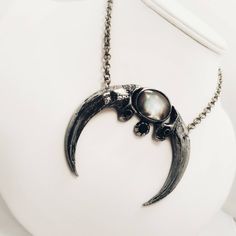 "Large cast eagle claw crescent moon with 25x18 black Tahiti shell cabachon Lead-free pewter. Pendant 3.5\" x 3\" Chain 17\" - 19\" adjustable Always ethically sourced bones. Nothing has ever been harmed for the purpose of our jewelry. All pieces are made-to-order despite the \"in stock\" number in the listing. Time frame varies from piece to piece so please message us if you need something by a certain date and we will do our best. A portion of our profits will be regularly donated to organizat Silver Metal Jewelry With Claw Shape, Unique Silver Claw Necklace, Unique Claw Shaped Silver Necklace, Cabachon Jewelry, Crow Necklace, Harpy Eagle, Claw Necklace, Eagle Claw, Pewter Pendant