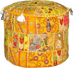 an orange and yellow patchwork poufce with tassels on the top