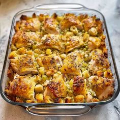 a casserole dish with chicken and vegetables in it on a counter top, ready to be eaten