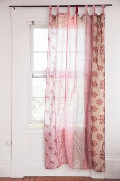 the curtains are hanging in front of the window and there is no image on it