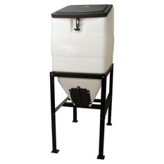 a white and black cooler sitting on top of a metal stand