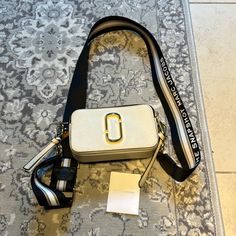 Marc Jacobs Snapshot Camera Bag Brand New, Never Been Worn Out Chic Evening Bags With Logo Strap, Luxury Beige Shoulder Bag With Logo Strap, Luxury White Shoulder Bag With Logo Strap, Beige Shoulder Bag With Logo Strap, White Crossbody Bag With Logo Strap, Modern White Shoulder Bag With Logo Strap, Chic White Shoulder Bag With Logo Strap, Rectangular Shoulder Bag With Logo Strap For Shopping, Chic Shoulder Bag With Logo Strap For Daily Use