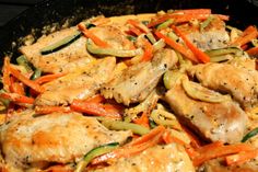 chicken and vegetables cooking in a skillet