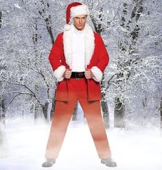 a man dressed as santa claus standing in the snow with his hands on his hips