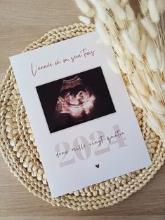 a greeting card with an image of a baby's hand on it and wheat in the background