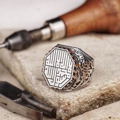 Experience the spiritual essence with our handcrafted men's silver ring, featuring the Kalima, 'لا إله إلا الله محمد رسول الله' (There is no deity but Allah, Muhammad is the messenger of Allah), elegantly inscribed in Arabic Kufic calligraphy. This octagonal ring is not only a statement of faith but also a testament to the artistry of Islamic calligraphy. A perfect blend of devotion and craftsmanship, it makes an exceptional gift for any occasion. * Discover our handmade Agate stone minimal ring Artisan Engraved Ring For Gift, Traditional Rings With Engraving Option As Gift, Artisan Engraved Signet Ring For Gift, Artisan Engraved Signet Ring Gift, Traditional Silver Signet Ring As Gift, University Symbol, Islamic Ring, Mens Luxury Accessories, Kufic Calligraphy