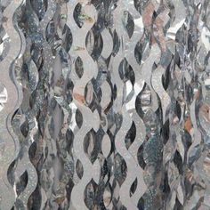 a close up view of the glass curtain in front of a window that has many circles on it