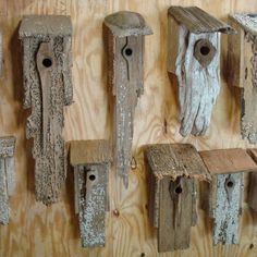 several wooden bird houses hanging on a wall