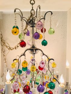 a chandelier with lots of colorful glass beads hanging from it's sides