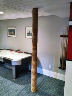 a game room with a pool table and foo - pong tables in the corner