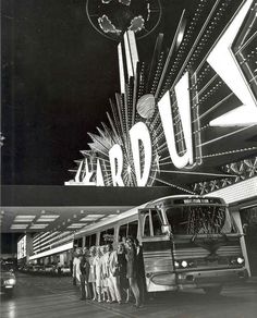 an old black and white photo of people standing in front of a bus with the word ardu on it