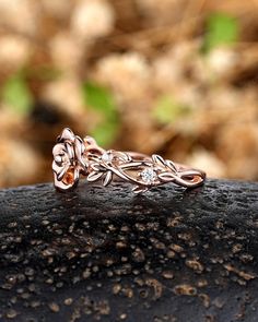 a close up of a ring on top of a rock