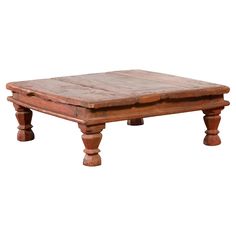 an old wooden coffee table with two legs